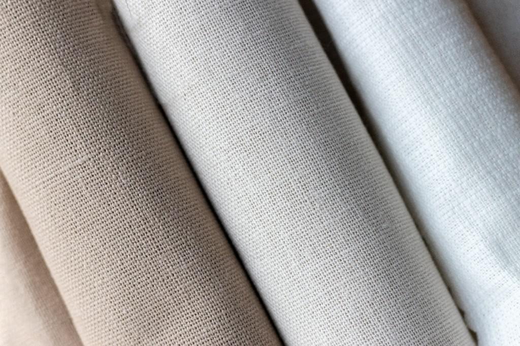 Natural fabric rolls in cream and white tones