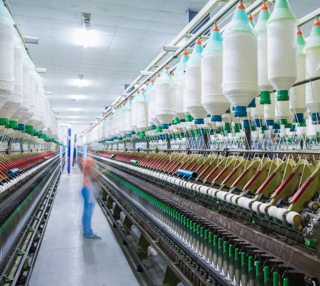 Spinning mill aisle with yarn bobbins in production