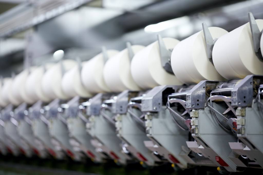 Industrial spinning line with white yarn bobbins