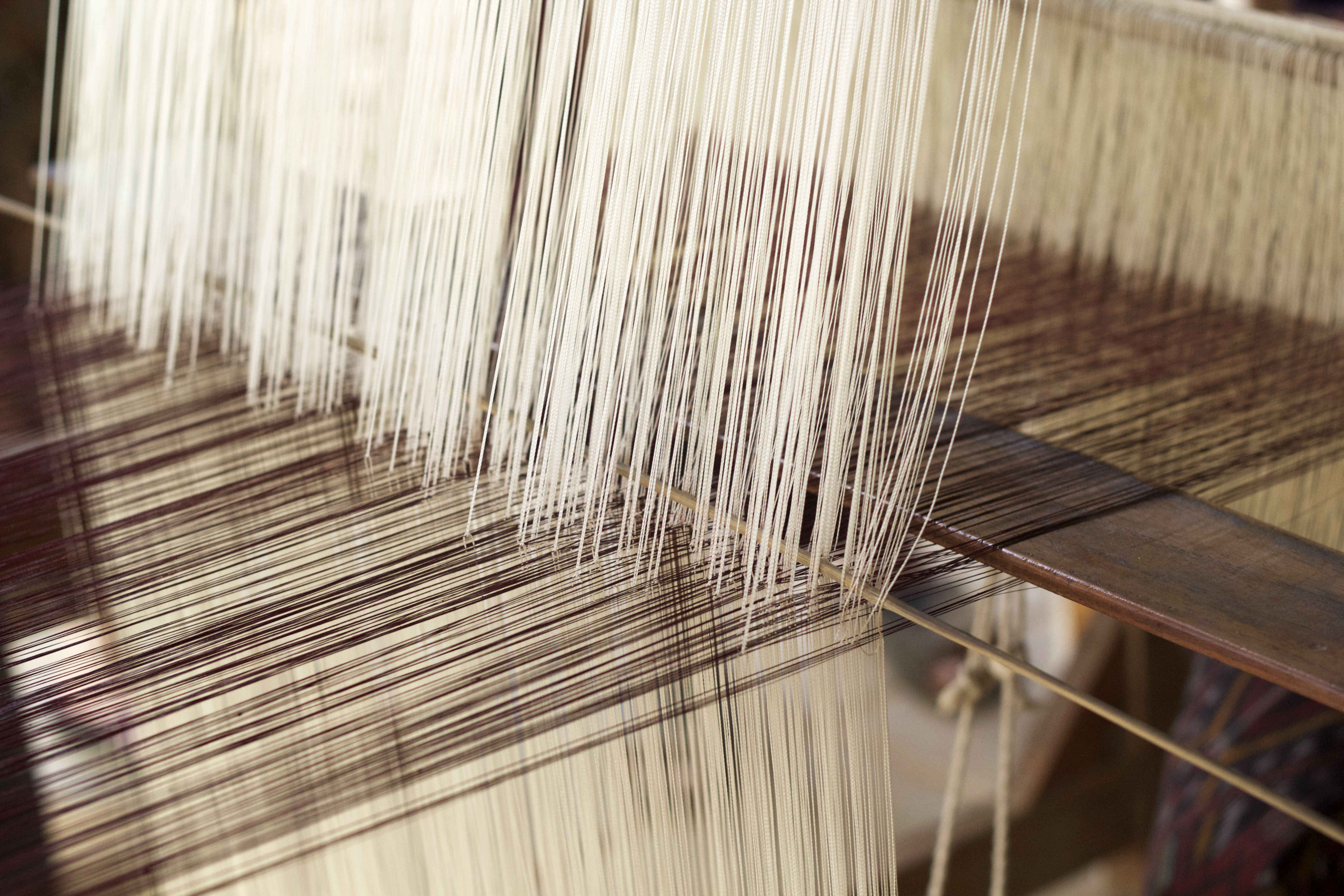 Close-up of warp and weft on a weaving loom