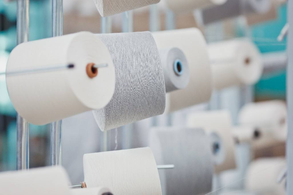Close-up of yarn cones on a creel
